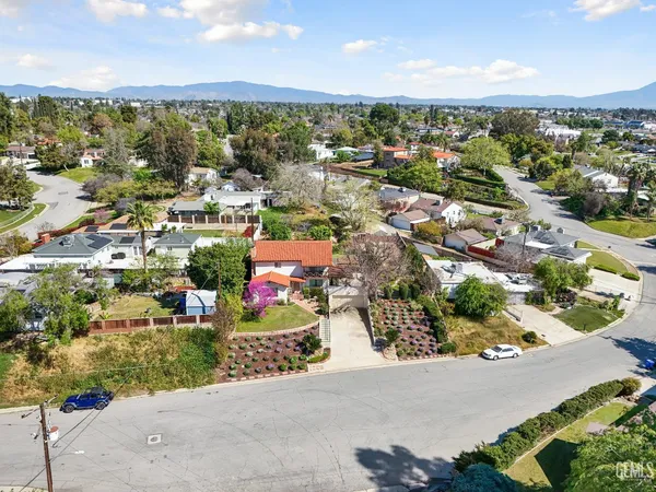 an aerial view of residential houses with outdoor space and street view