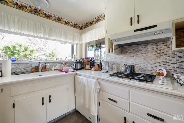 a kitchen with stainless steel appliances a sink and cabinets