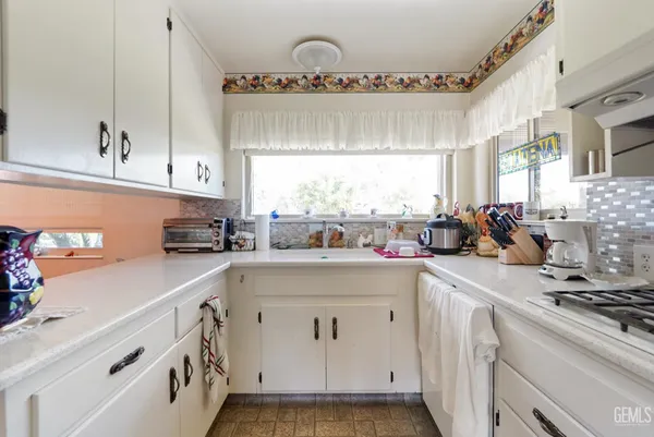 a kitchen with a sink stove and cabinets