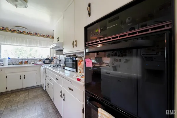 a kitchen with appliances cabinets and a sink