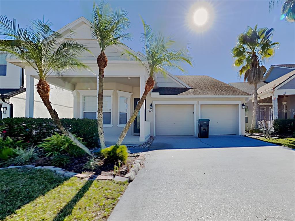 14136 Bradbury Road Orlando, FL 32828 - Photo 1 of 24 a front view of a house with a yard and potted plants