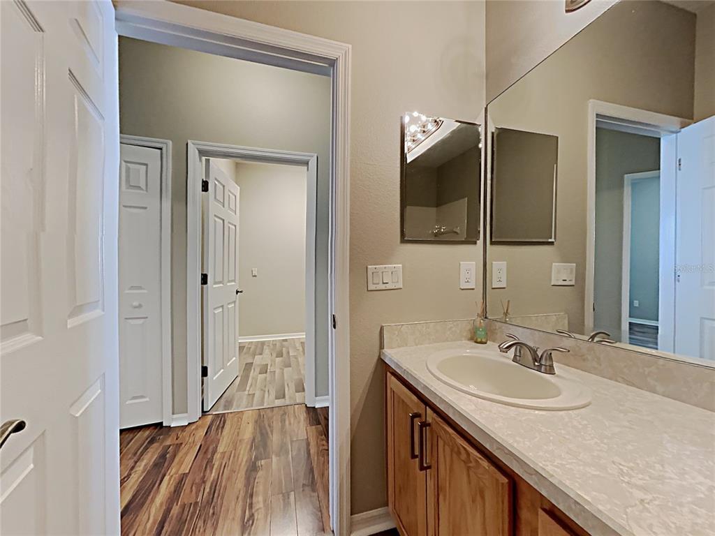 14136 Bradbury Road Orlando, FL 32828 - Photo 12 of 24 a bathroom with a sink a mirror and a shower