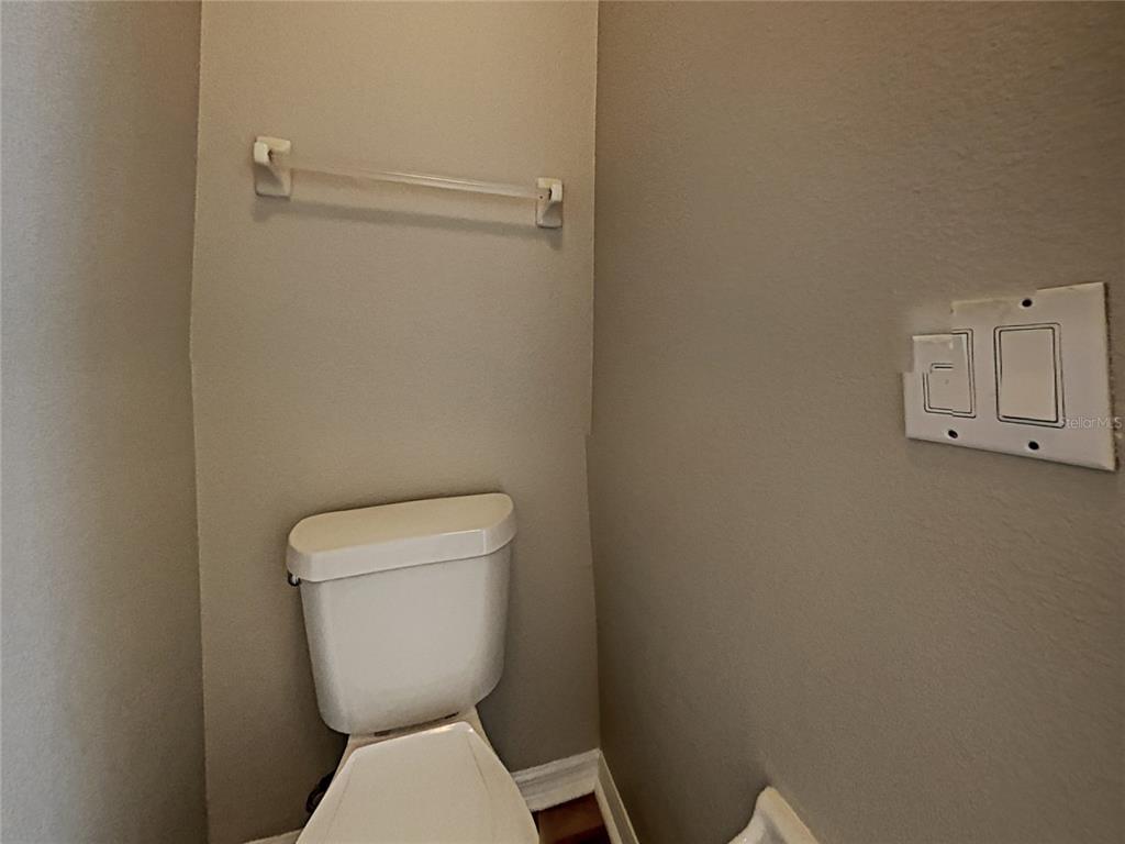 14136 Bradbury Road Orlando, FL 32828 - Photo 13 of 24 a white toilet sitting next to a white wall