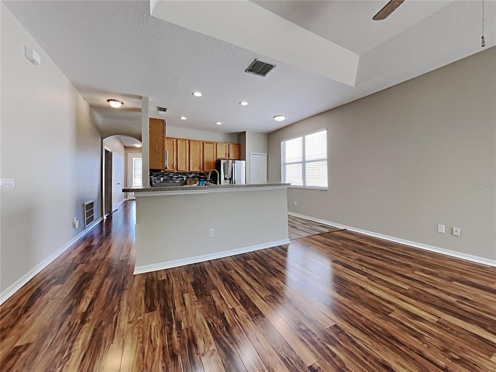 14136 Bradbury Road Orlando, FL 32828 - Photo 20 of 24 a view of kitchen and hall with wooden floor