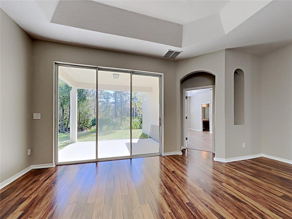14136 Bradbury Road Orlando, FL 32828 - Photo 4 of 24 a view of empty room with wooden floor and fan