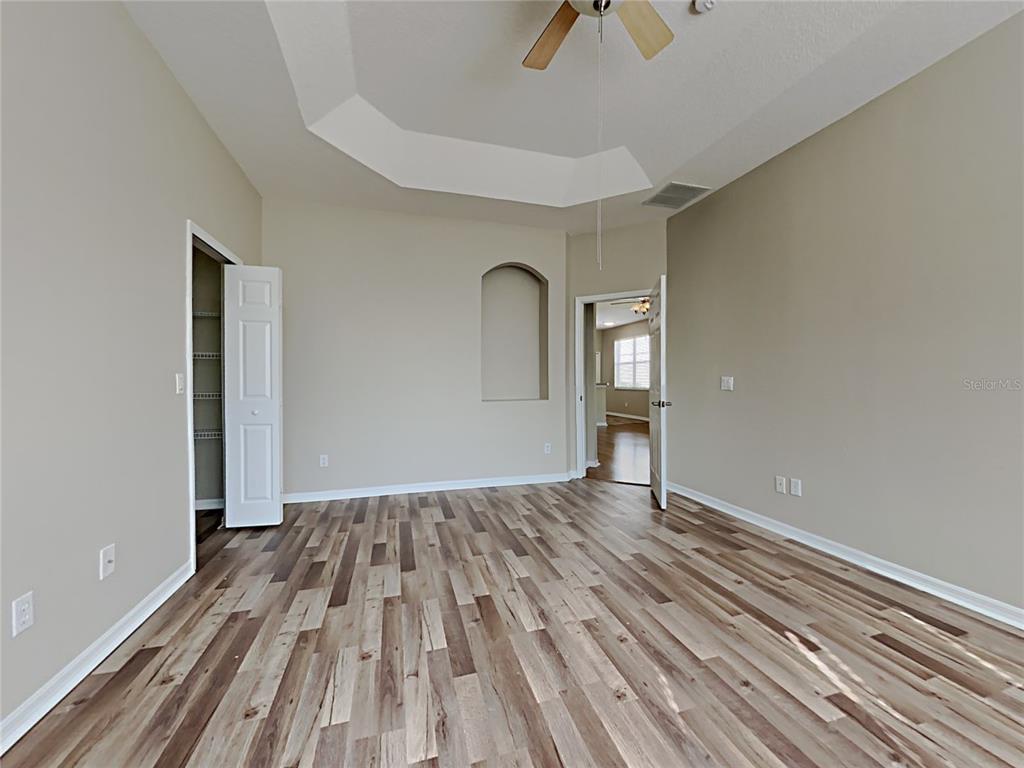 14136 Bradbury Road Orlando, FL 32828 - Photo 5 of 24 a view of empty room with wooden floor and fan
