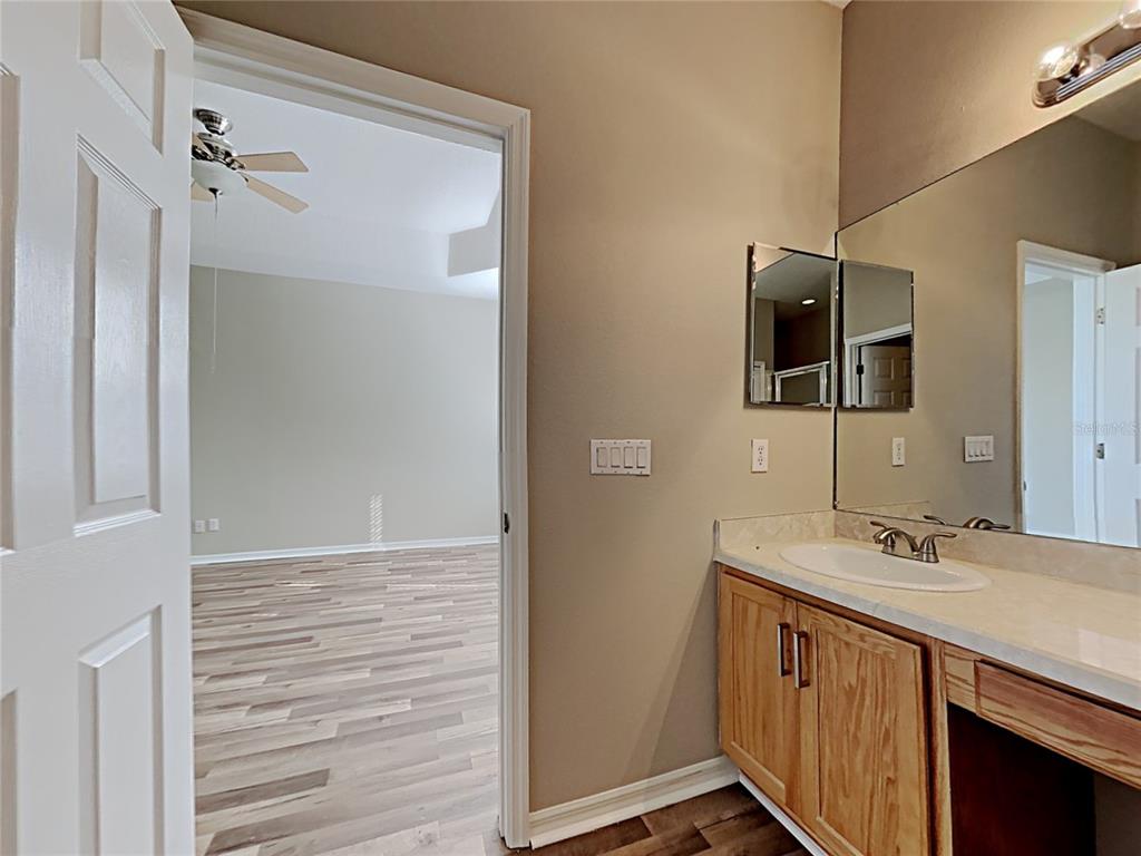 14136 Bradbury Road Orlando, FL 32828 - Photo 6 of 24 a bathroom with a sink a mirror and shower