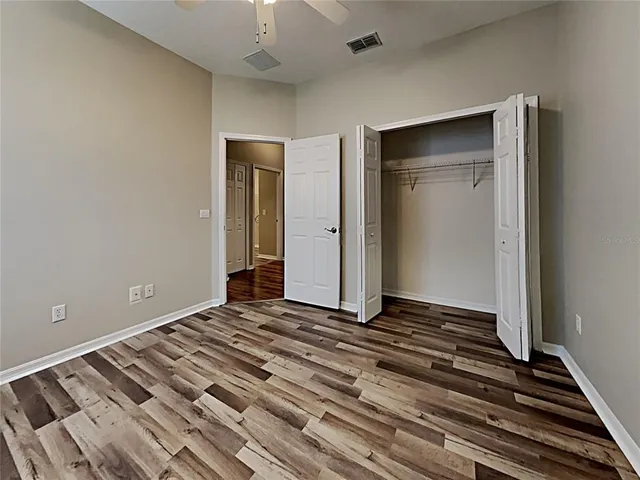 a view of an empty room and wooden floor