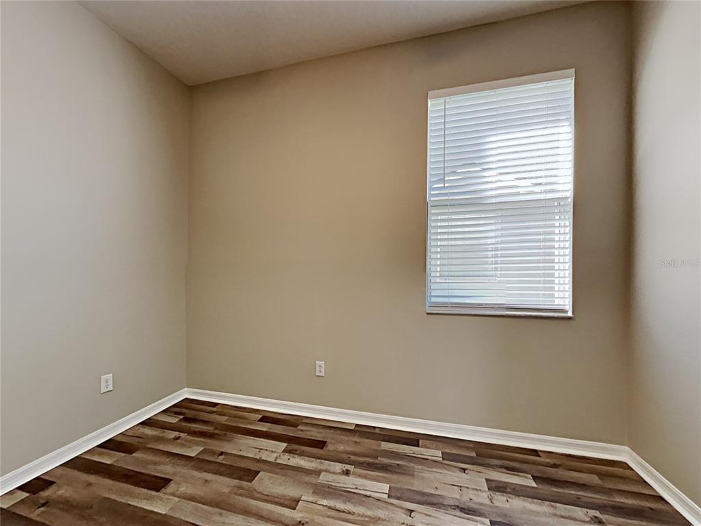 14136 Bradbury Road Orlando, FL 32828 - Photo 10 of 24 a view of a room with wooden floor and a window