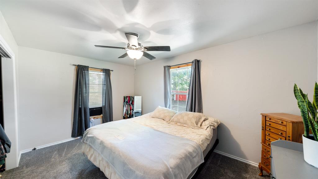 29080 Highway 19 Athens, TX 75752 - Photo 14 of 30 a spacious bedroom with a bed and a chandelier