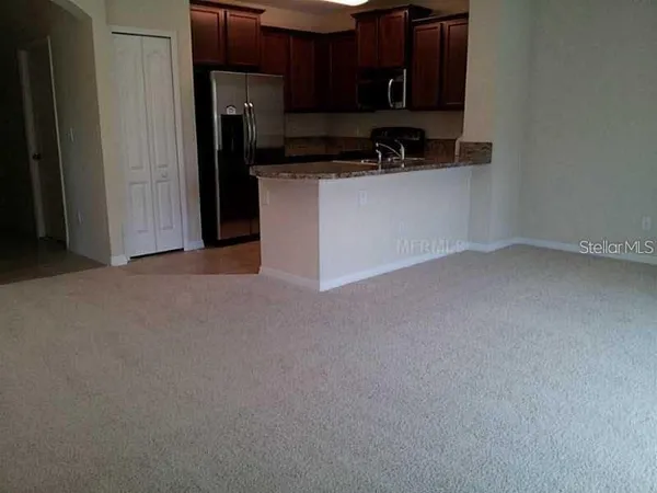 a kitchen with stainless steel appliances granite countertop a refrigerator a stove top oven a sink and dishwasher