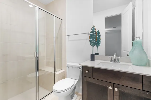 an empty room with wooden floor cabinet and windows
