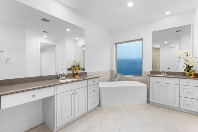 an empty room with a window and a ceiling fan