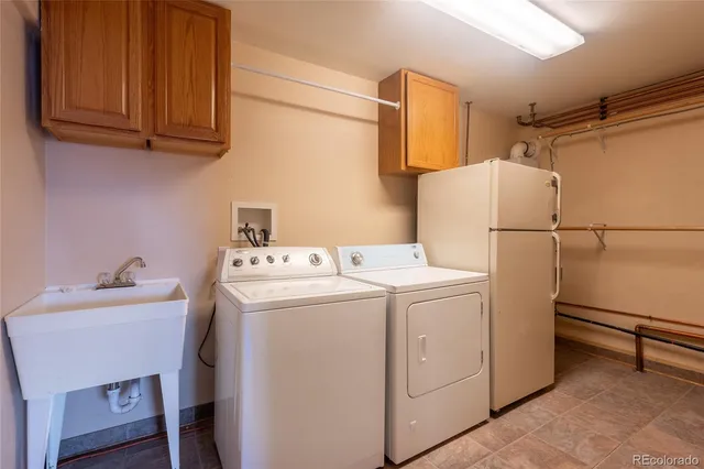 a view of storage and utility room with two washing machine