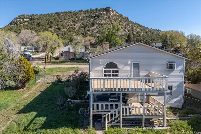 a balcony with wooden floor and city view