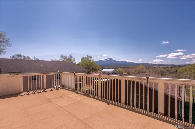 a backyard of a house with a garden and barbeque oven