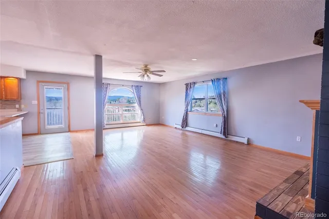 a view of a hallway with wooden floor and closet