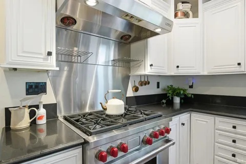 a kitchen with stainless steel appliances granite countertop a stove and a refrigerator