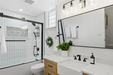 a bathroom with a sink toilet and shower