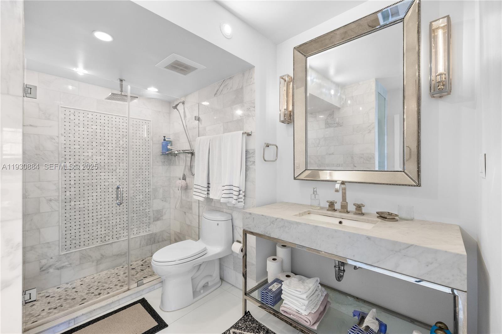 100 Lincoln Road, Unit 1523 Miami Beach, FL 33139 - Photo 11 of 24 a bathroom with a sink toilet a mirror and shower