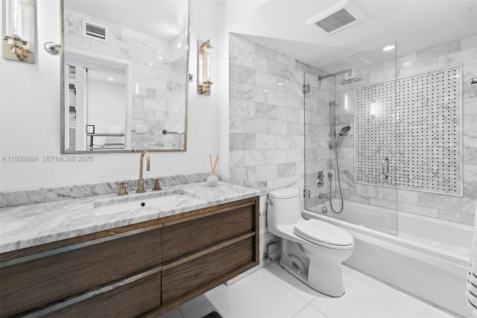 100 Lincoln Road, Unit 1523 Miami Beach, FL 33139 - Photo 17 of 24 a bathroom with a sink a toilet and shower