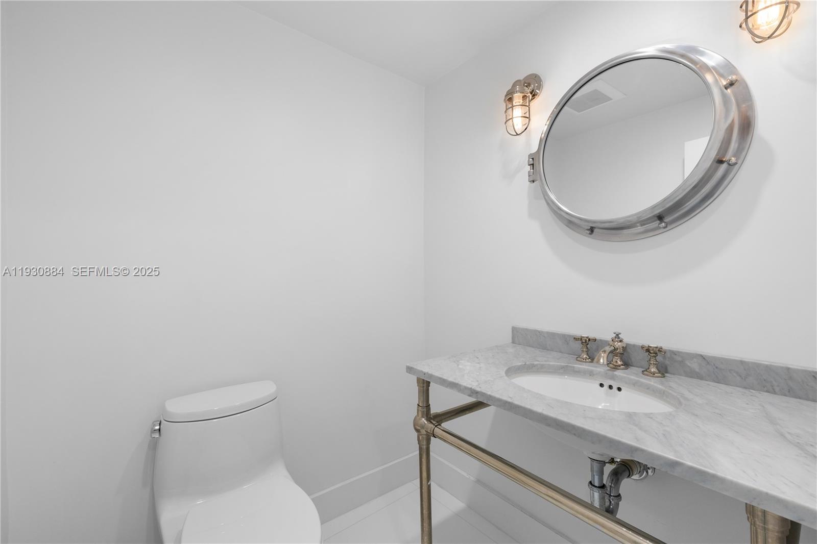 100 Lincoln Road, Unit 1523 Miami Beach, FL 33139 - Photo 18 of 24 a bathroom with a granite countertop toilet a sink and mirror