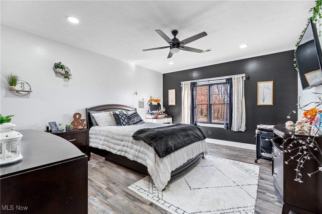 37250 Harry's Ridge Road Barnesville, OH 43713 - Photo 28 of 50 Lower level Bedroom featuring wood-type flooring and ceiling fan