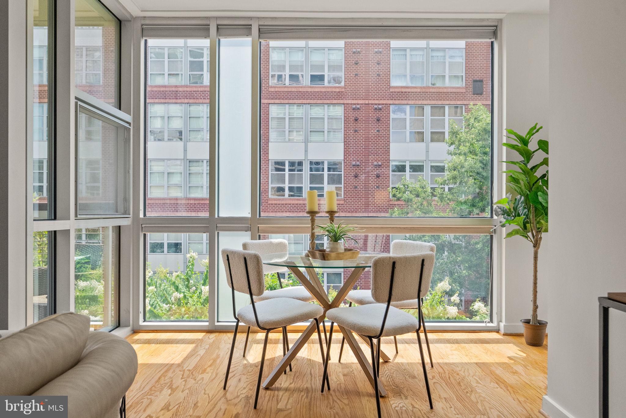 1300 13th Street Northwest, Unit 408 Washington, DC 20005 - Photo 18 of 47 a dining room with furniture a chandelier and wooden floor