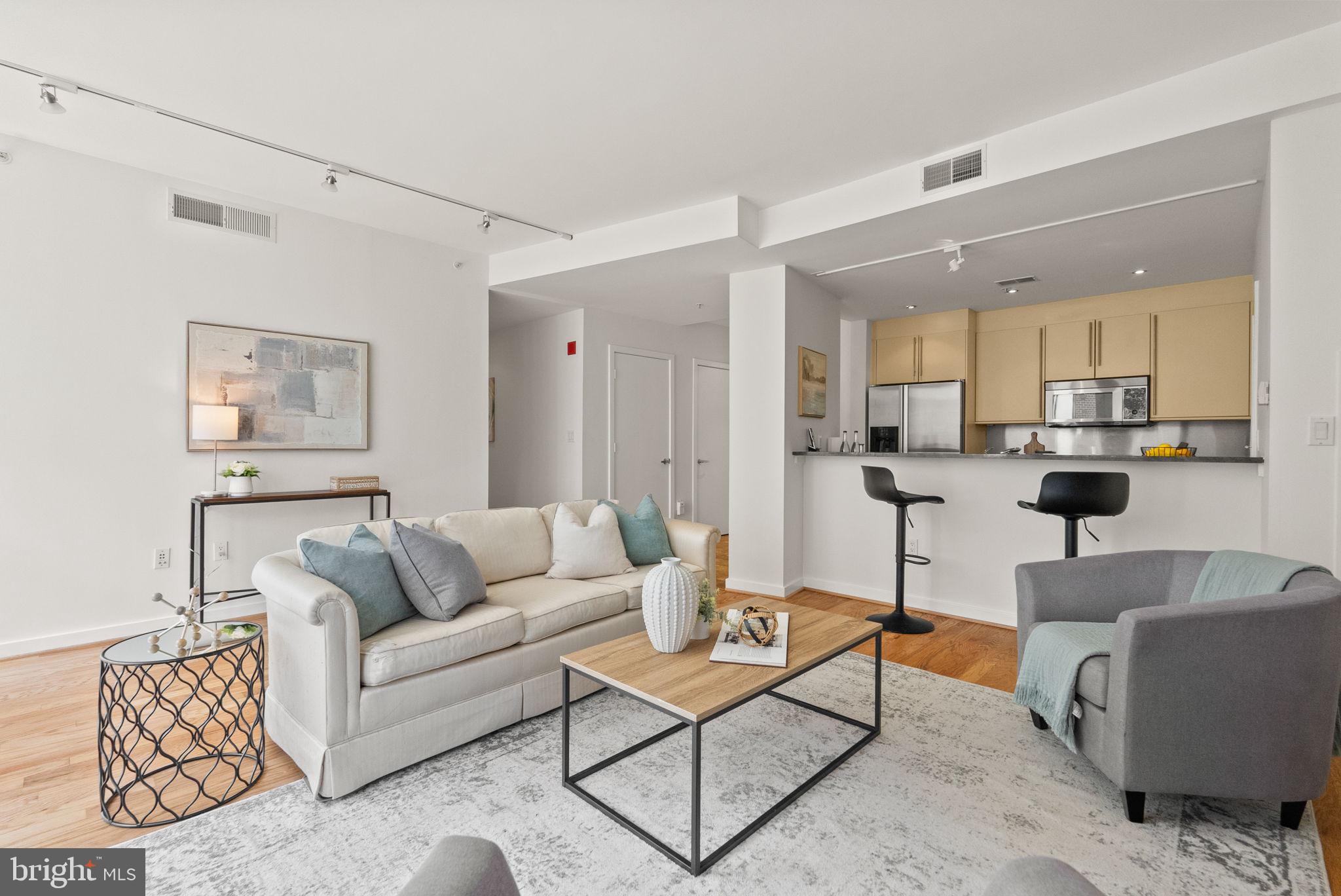 1300 13th Street Northwest, Unit 408 Washington, DC 20005 - Photo 20 of 47 a living room with furniture and kitchen view