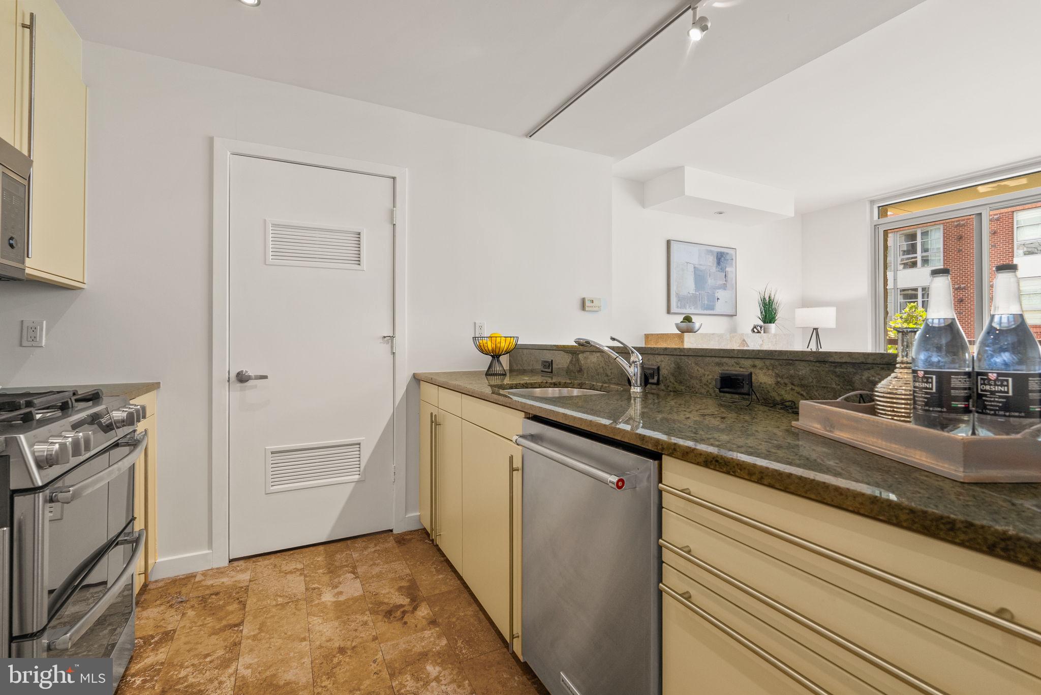 1300 13th Street Northwest, Unit 408 Washington, DC 20005 - Photo 23 of 47 a kitchen with stainless steel appliances granite countertop a sink stove and cabinets