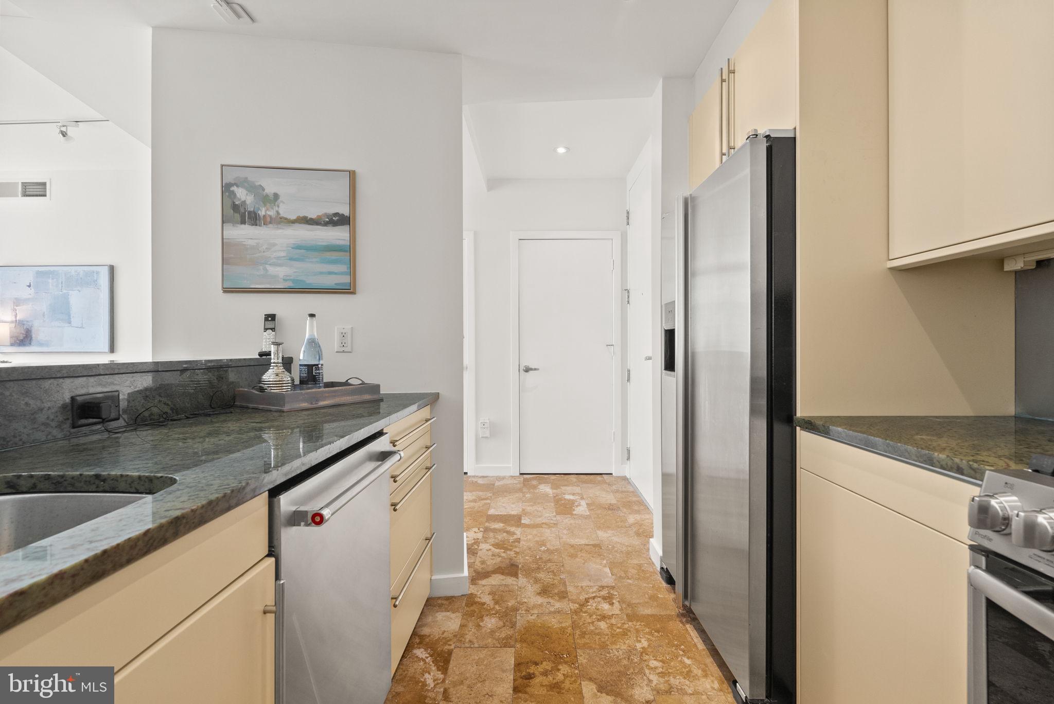 1300 13th Street Northwest, Unit 408 Washington, DC 20005 - Photo 25 of 47 a kitchen with stainless steel appliances granite countertop a sink and a refrigerator