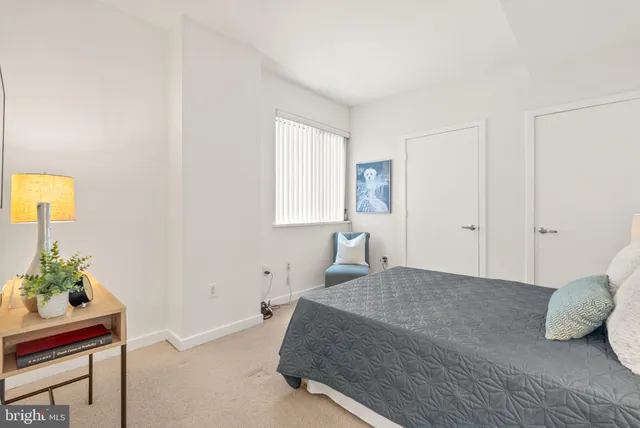 a bedroom with a bed and a potted plant