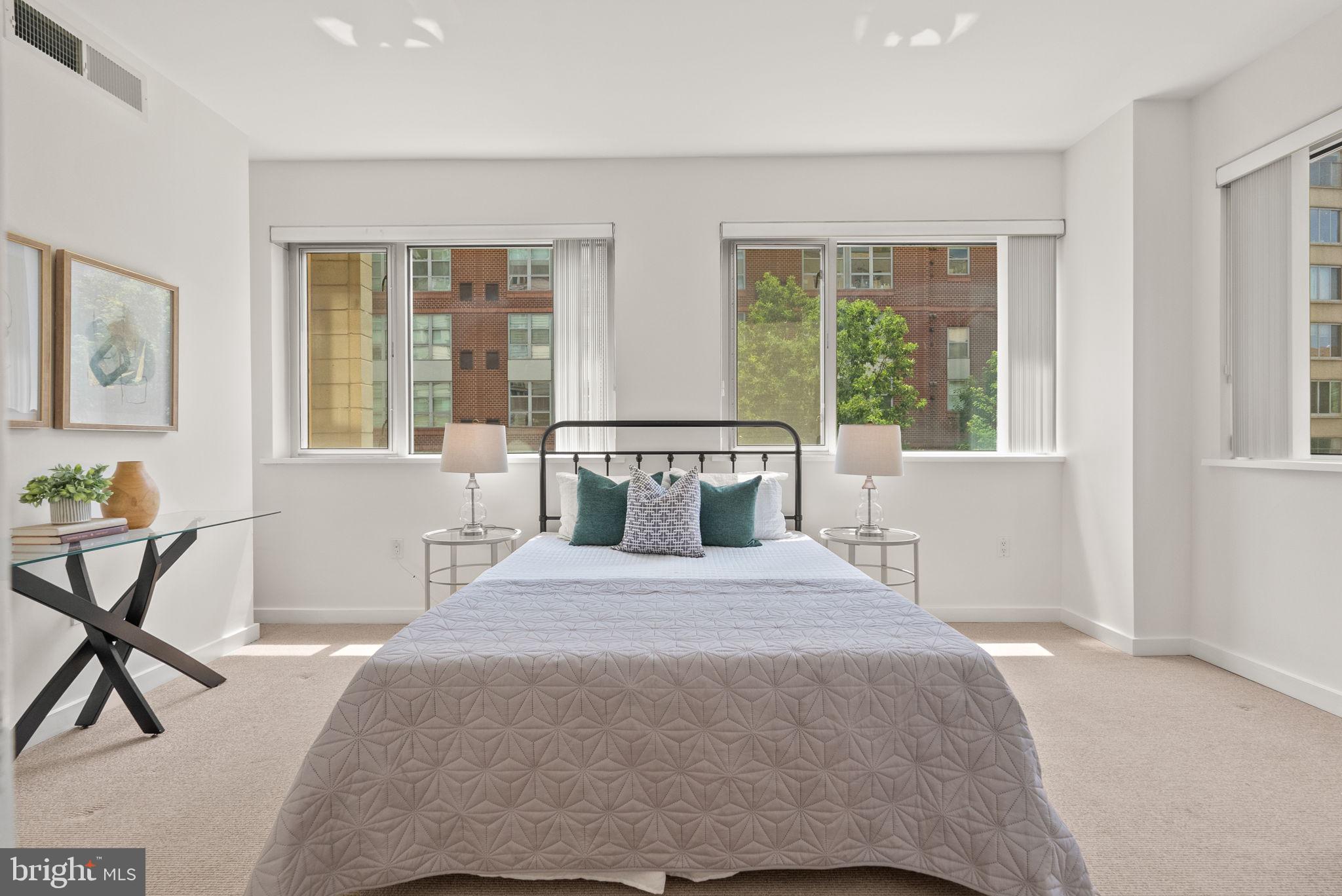 1300 13th Street Northwest, Unit 408 Washington, DC 20005 - Photo 31 of 47 a bedroom with a bed chair and next to a window