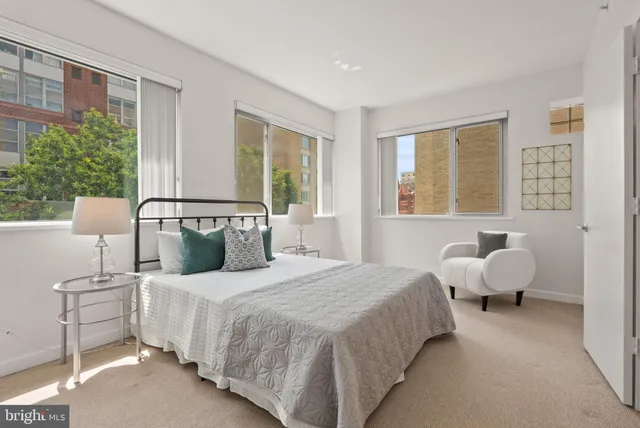 a bedroom with bed and large window