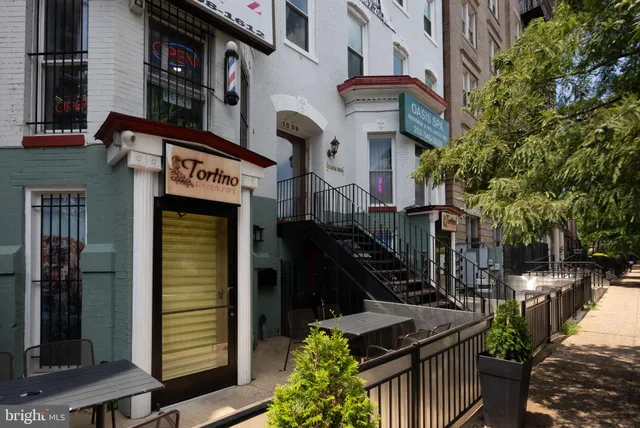 a view of a building with sitting area