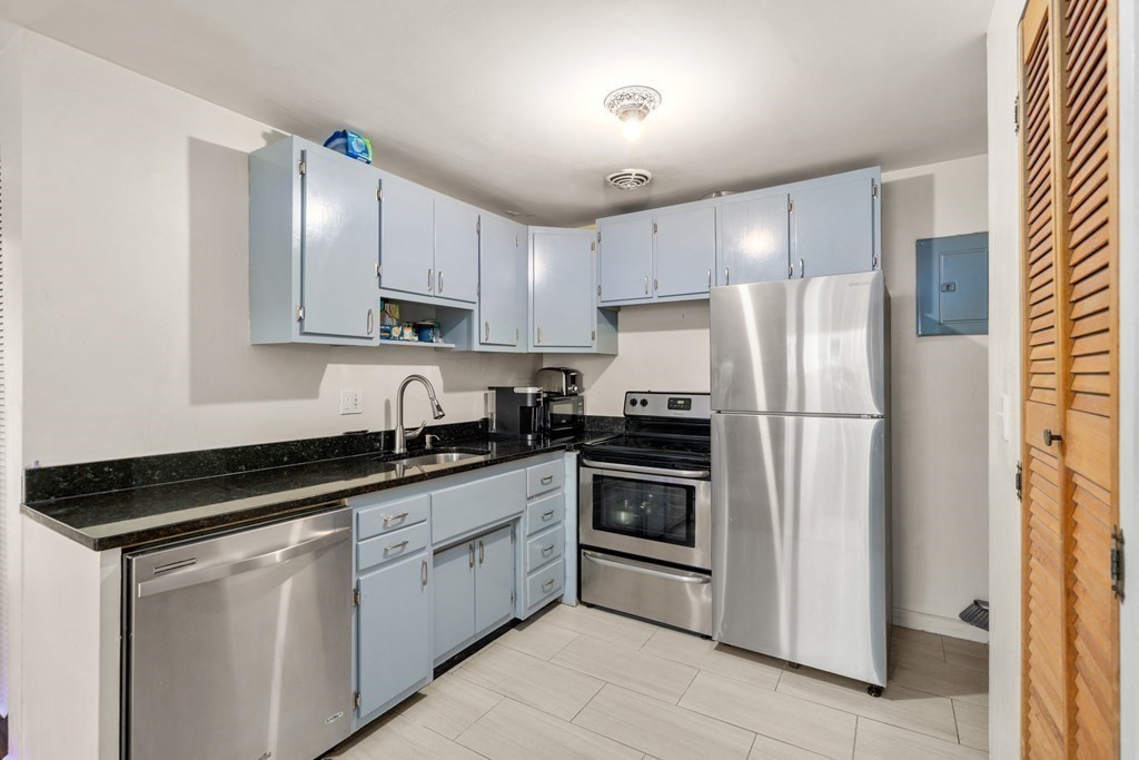 194 Lexington Street, Unit 1 Watertown, MA 02472 - Photo 6 of 10 a kitchen with stainless steel appliances granite countertop a stove a refrigerator and a sink