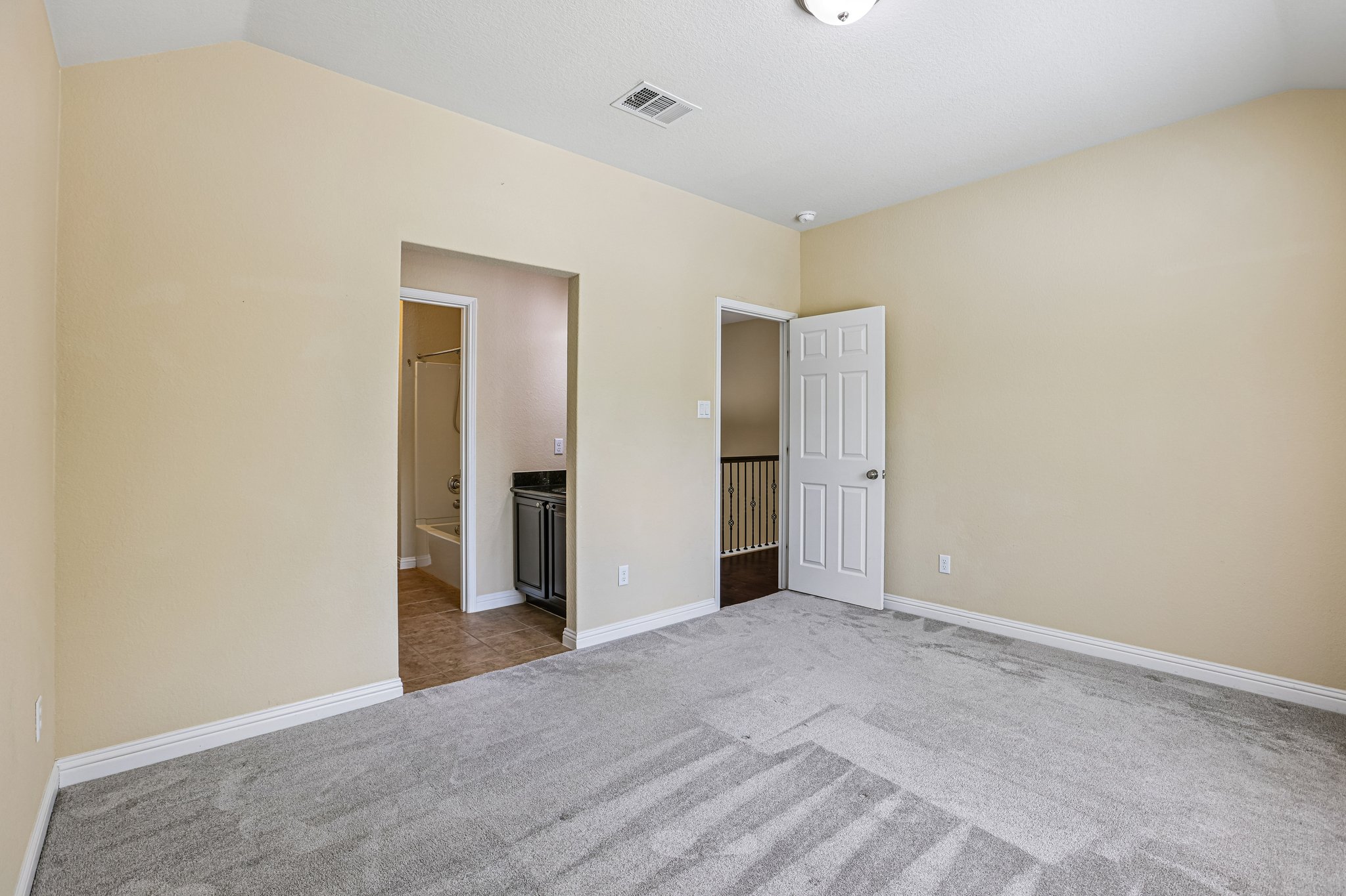 1924 Granite Springs Road Leander, TX 78641 - Photo 28 of 36 Guest bedroom #3 with a jack and jill bathroom.A spacious room offers ample personal space, featuring soft carpeting and direct bathroom access.