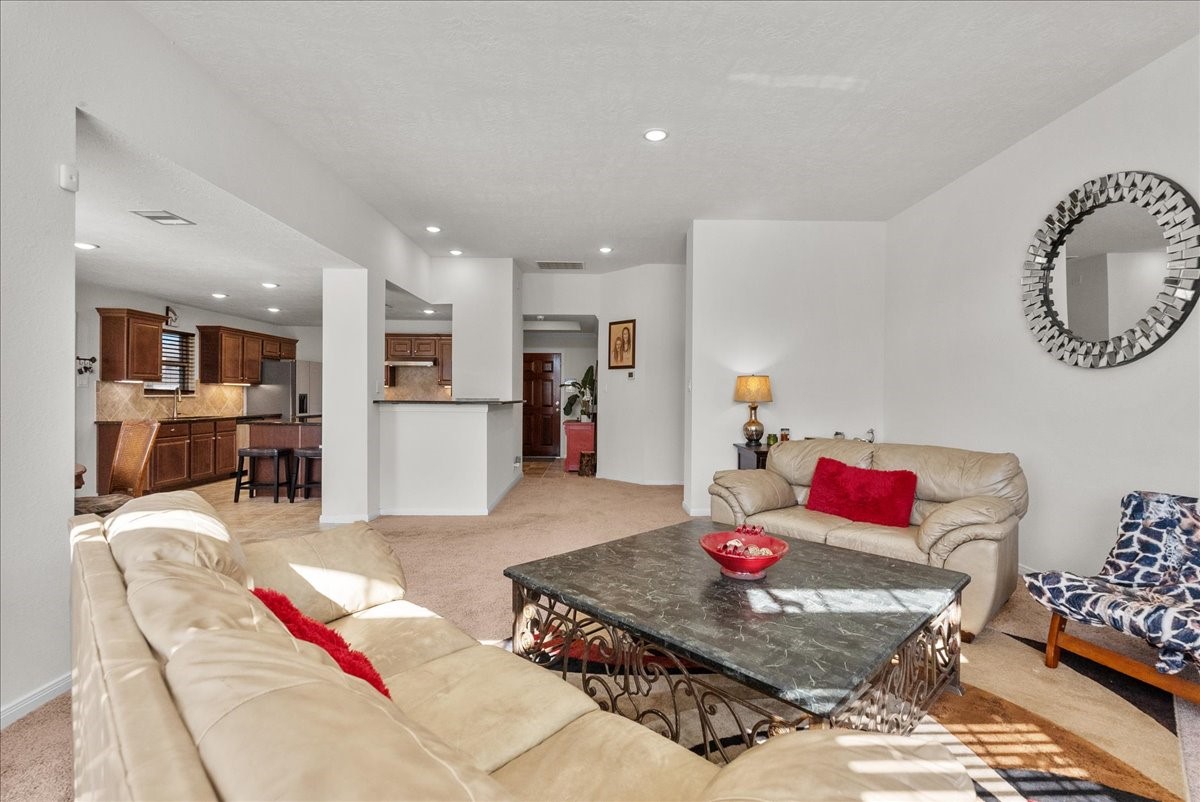 2111 Gilbert Road League City, TX 77573 - Photo 13 of 38 The living room features a cozy fireplace and is bathed in natural morning light through an abundance of windows