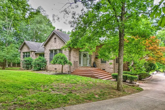 an aerial view of a house with a yard and street view