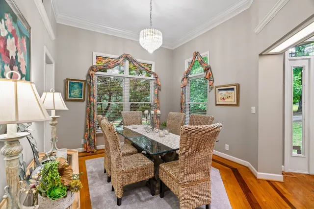 a dining room with furniture a flat screen tv and a chandelier
