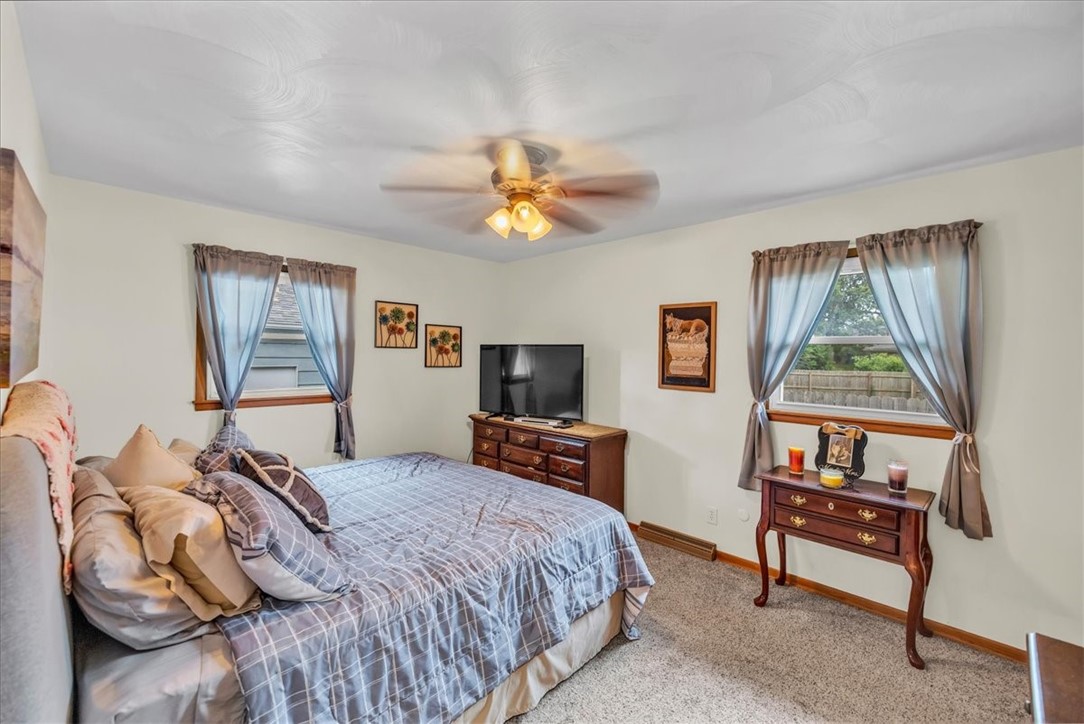 2220 West Ravina Park Road Decatur, IL 62526 - Photo 17 of 36 a bedroom with a bed and a flat screen tv