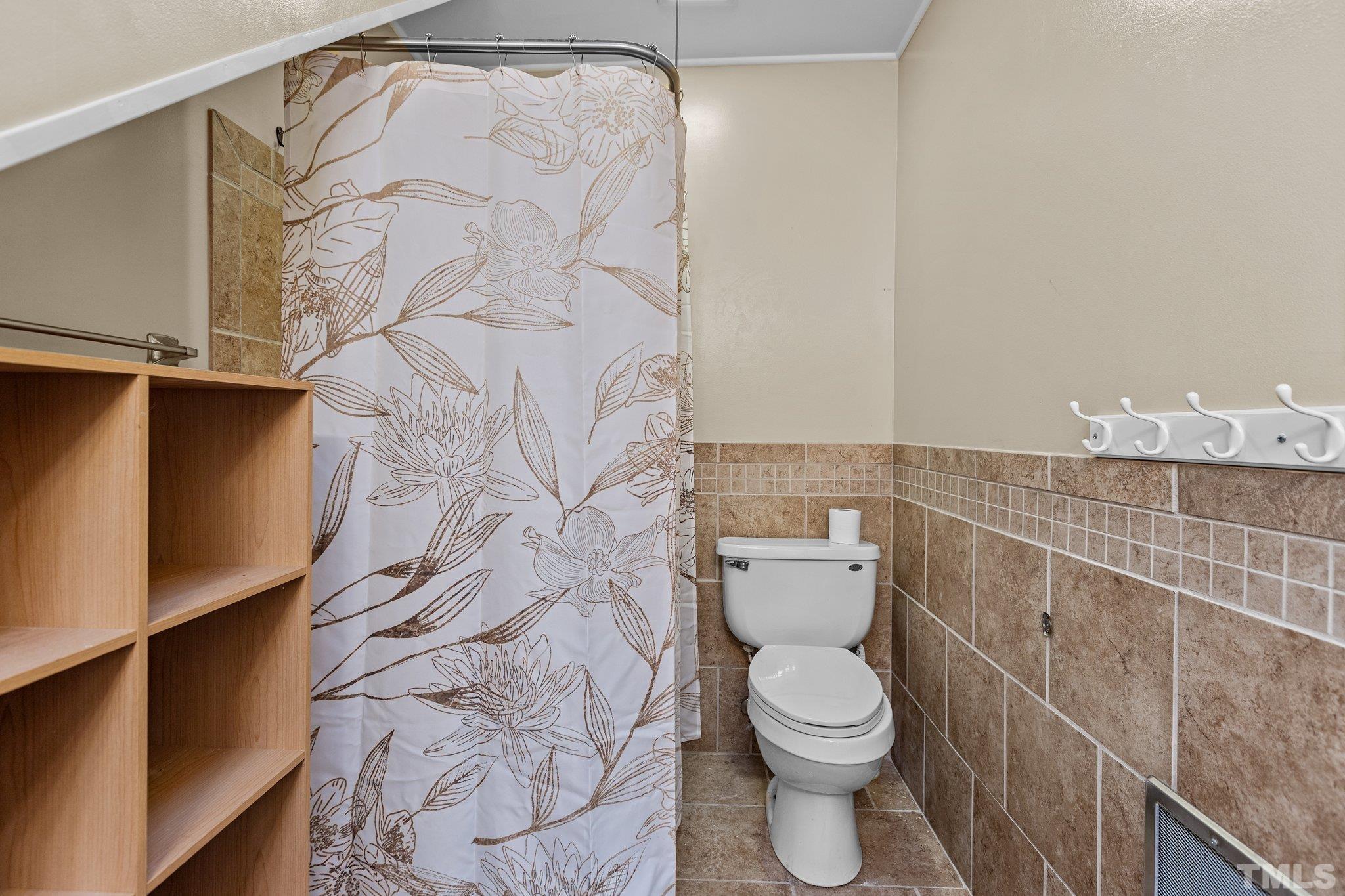 300 Rabbit Run Pittsboro, NC 27312 - Photo 19 of 38 a white toilet sitting next to a shower curtain