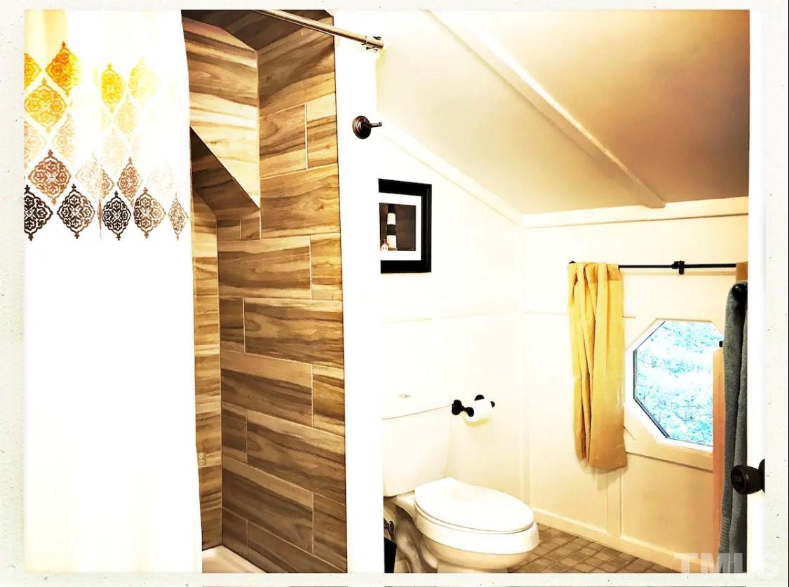 300 Rabbit Run Pittsboro, NC 27312 - Photo 25 of 38 a bathroom with a toilet and a shower curtain