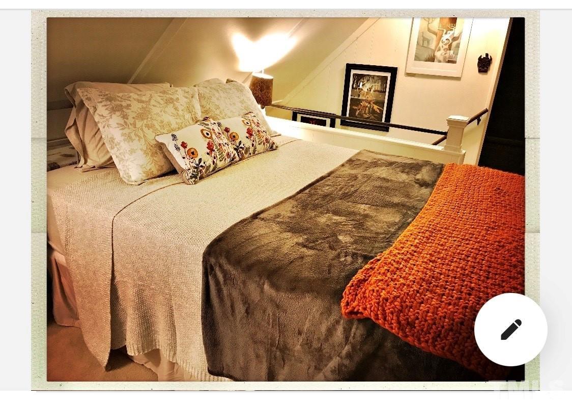 300 Rabbit Run Pittsboro, NC 27312 - Photo 30 of 38 a bedroom with a bed and painting on the wall