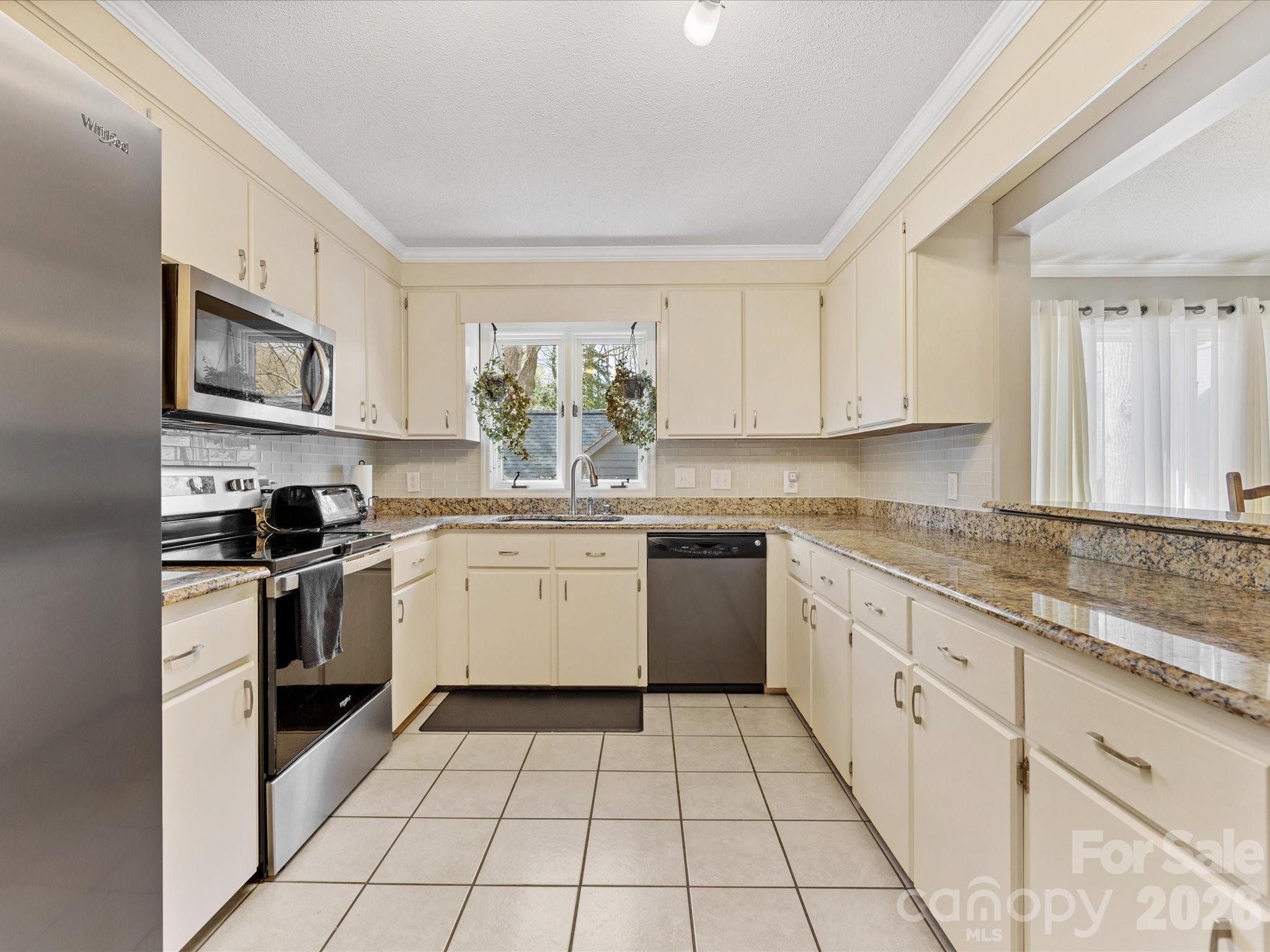 3489 Lake Shore Road South Denver, NC 28037 - Photo 11 of 31 a kitchen with a sink a stove top oven and white cabinets