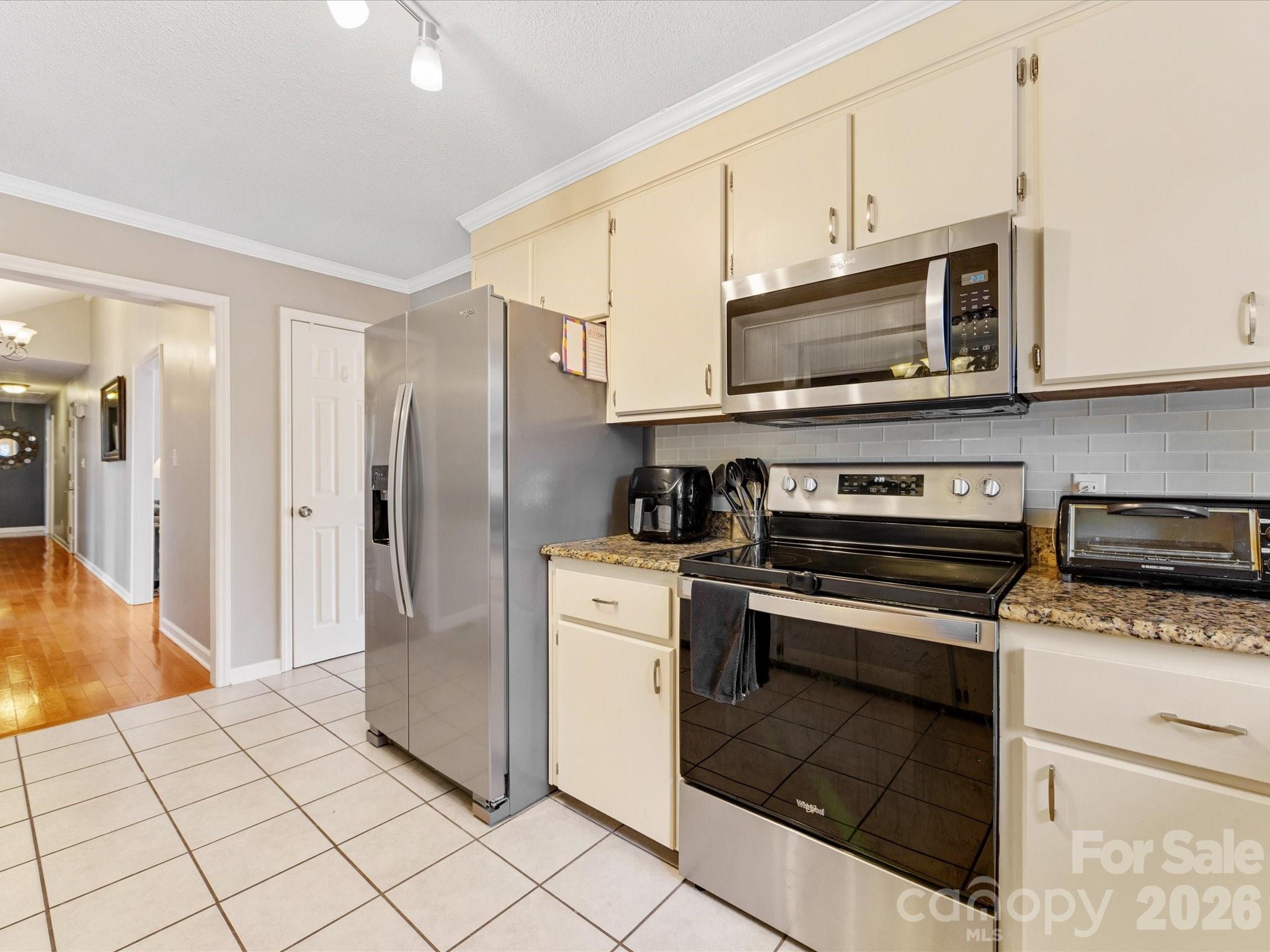 3489 Lake Shore Road South Denver, NC 28037 - Photo 13 of 31 a kitchen with stainless steel appliances granite countertop a stove a refrigerator and a microwave