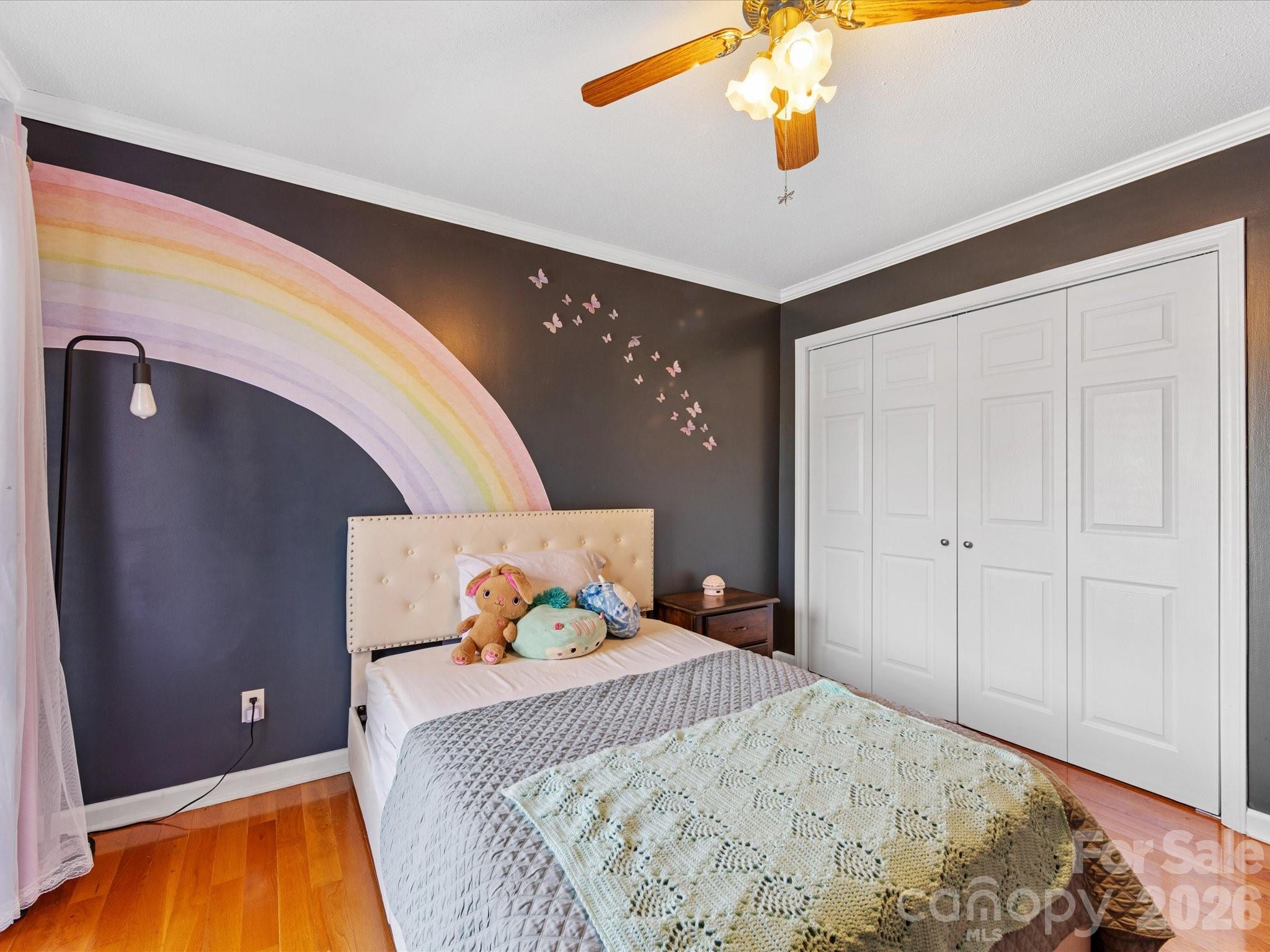 3489 Lake Shore Road South Denver, NC 28037 - Photo 20 of 31 a bedroom with a bed and a chandelier