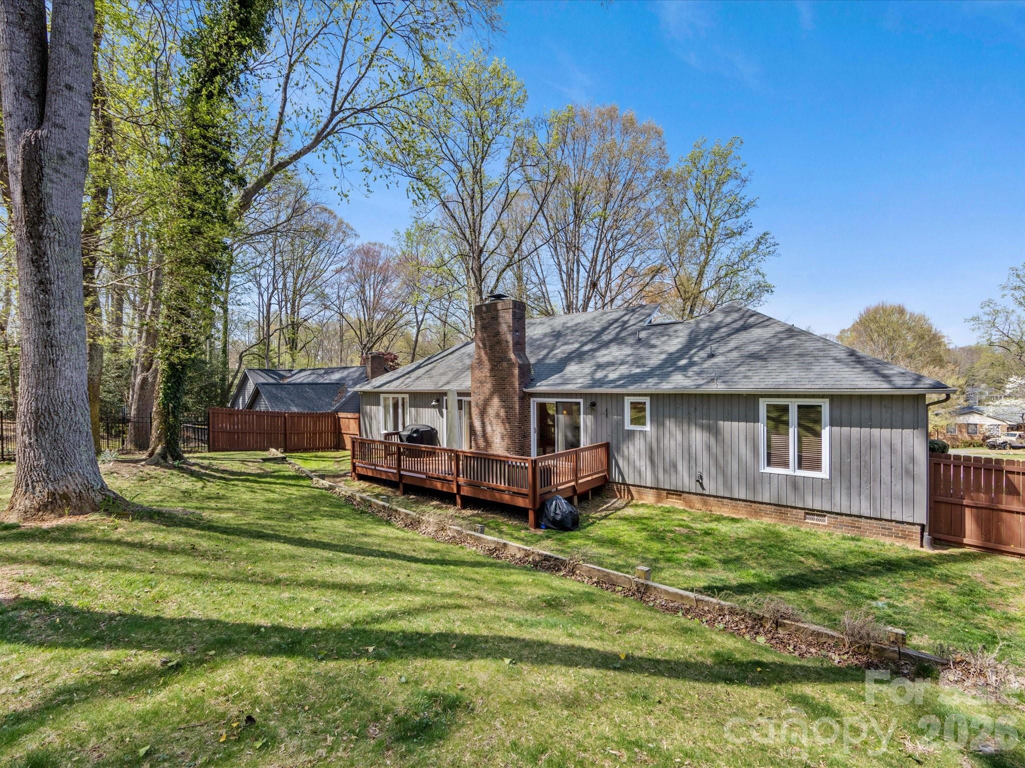 3489 Lake Shore Road South Denver, NC 28037 - Photo 29 of 31 a front view of a house with a garden and trees