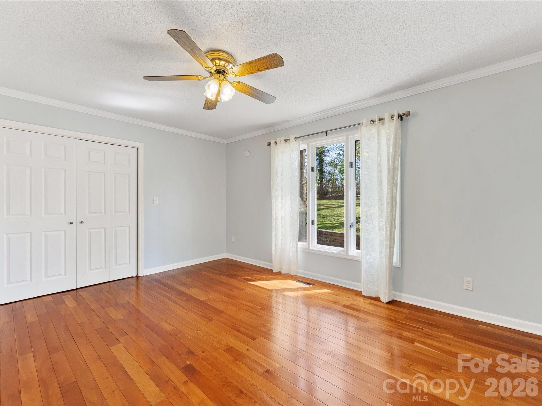 3489 Lake Shore Road South Denver, NC 28037 - Photo 10 of 31 a view of an empty room with wooden floor and a window