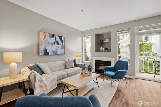 a living room with furniture a fireplace and a potted plant